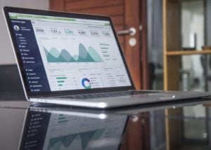 A laptop displaying numerical data and a graph