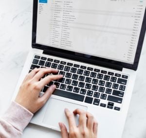 Aerial view of woman using a computer laptop checking her email