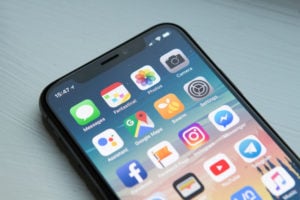 iphone X with apps on screen